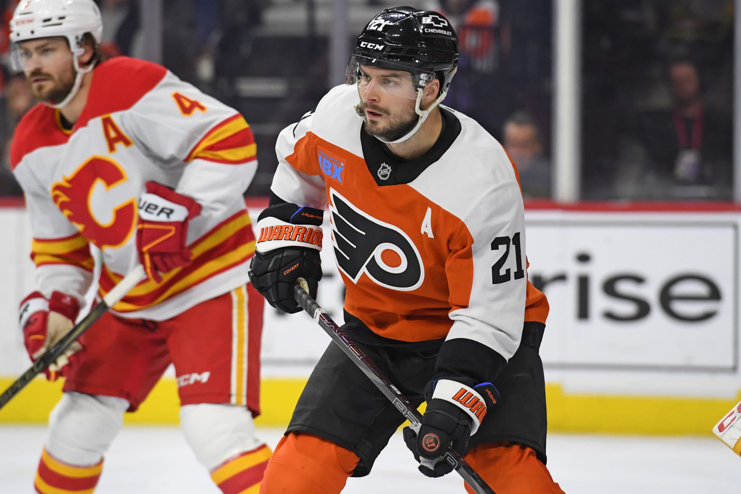 Scott Laughton in Philadelphia Flyers jersey, Calgary Flames skater in background