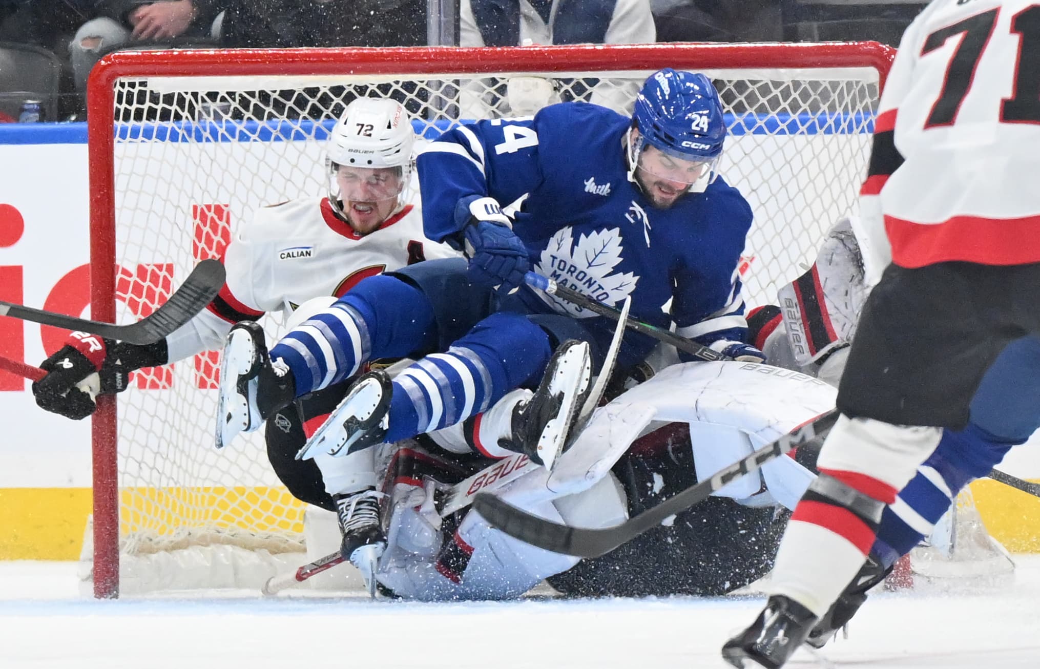 Toronto Maple Leafs Scott Laughton crashes into Linus Ullmark of the Ottawa Senators.